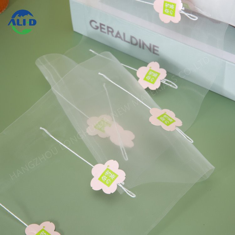 Obnovljiva piramidna folija za čajne vrečke z etiketo in vrvico